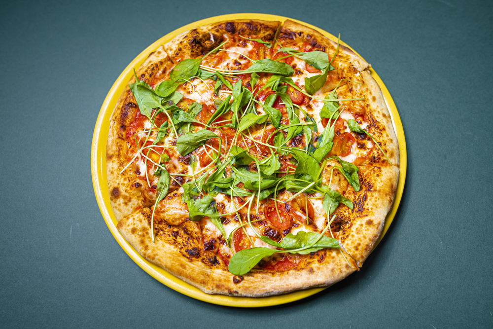 Pizza de arúgula y tomate cherry