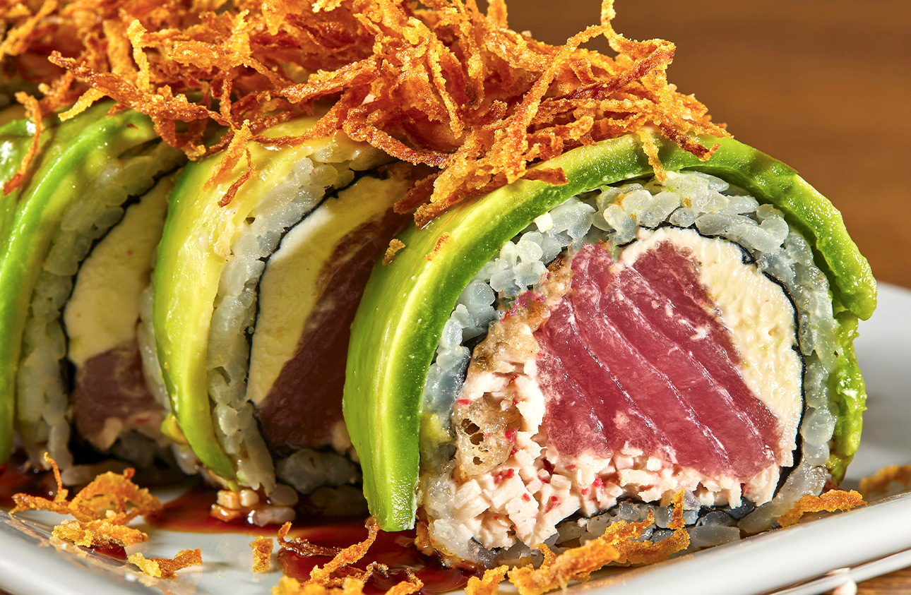 Roll de sushi con aguacate, atún y cebolla crujiente